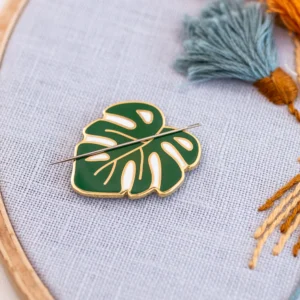 image of a monstera leaf-shaped needle minder holding an embroidery needle